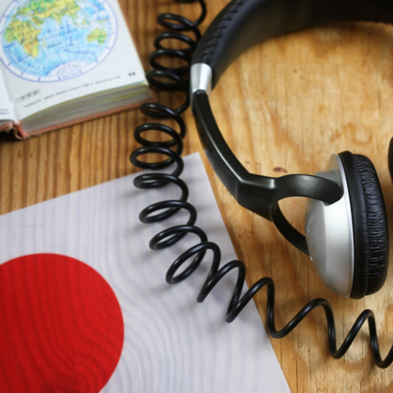 Headphones and a Japanese flag to represent professional Japanese translation services.